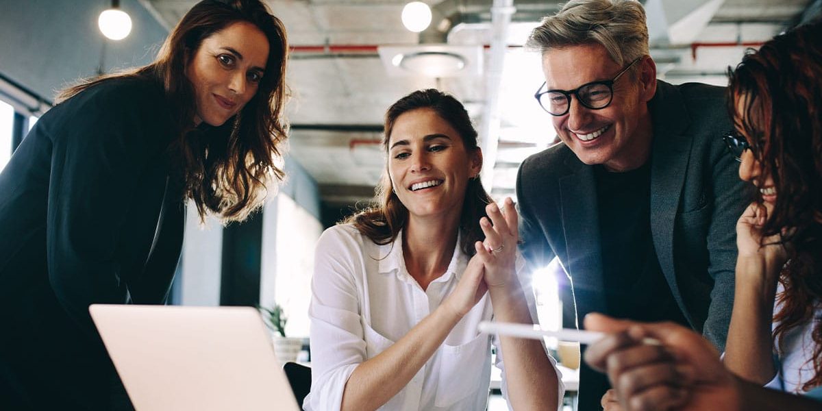 A Couple Of People That Are Looking At The Camera